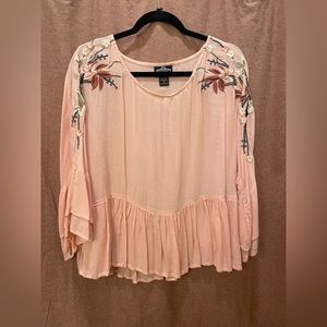 Pink blouse with flowers.
